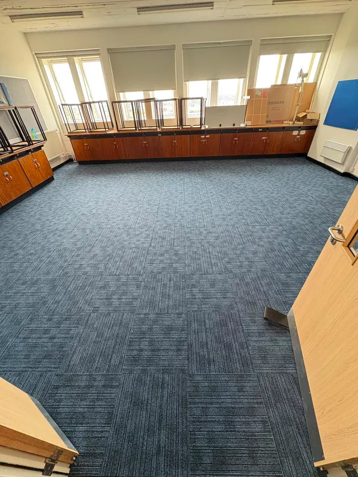 Blue carpet tiles fitted in a classroom