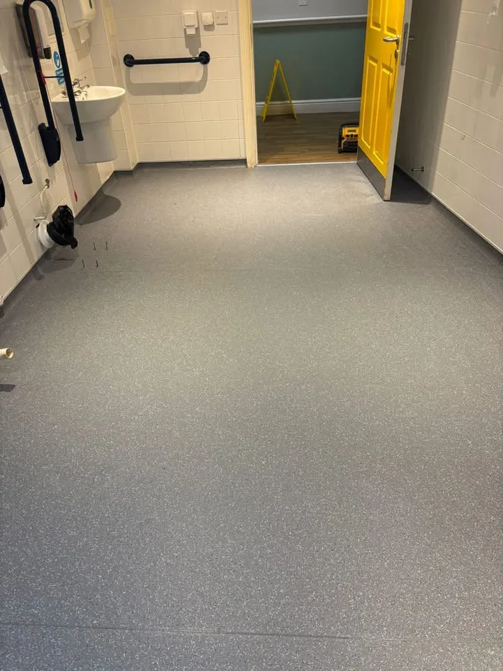 Grey flooring fitted in an accessible washroom